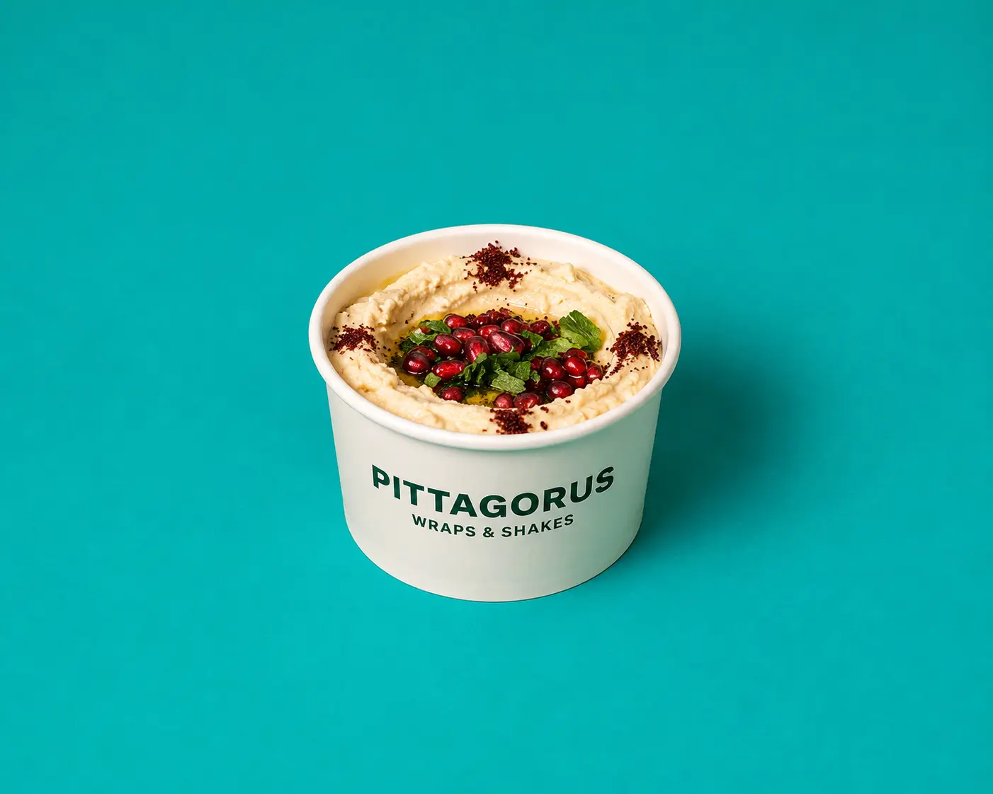 Tub of Pittagorus hummus topped with pomegranate, mint and sumac
