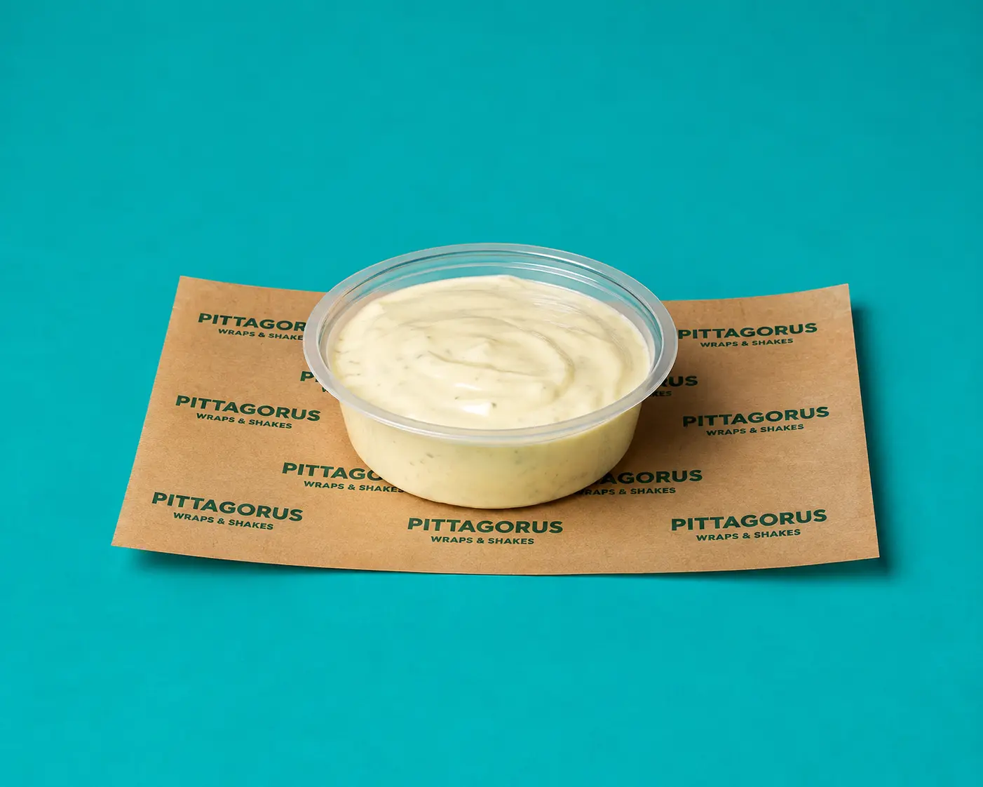 Tub of creamy garlic dip on Pittagorus paper