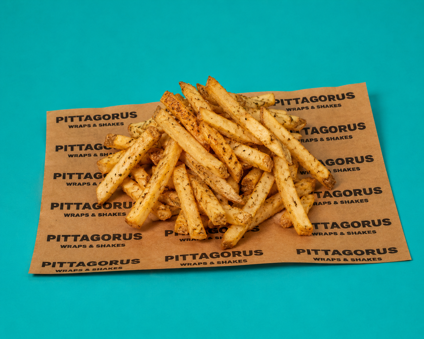 Oregano dusted hand cut chips on Pittagorus branded paper